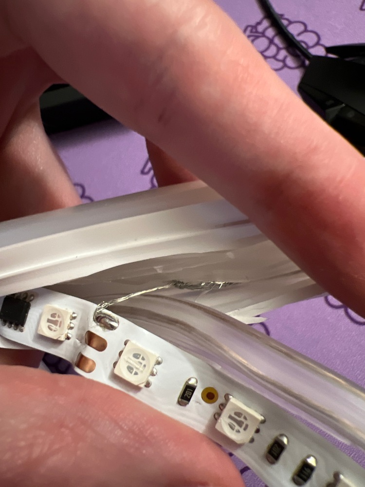 Wire soldered to LED strip and wound around a wire in the casing